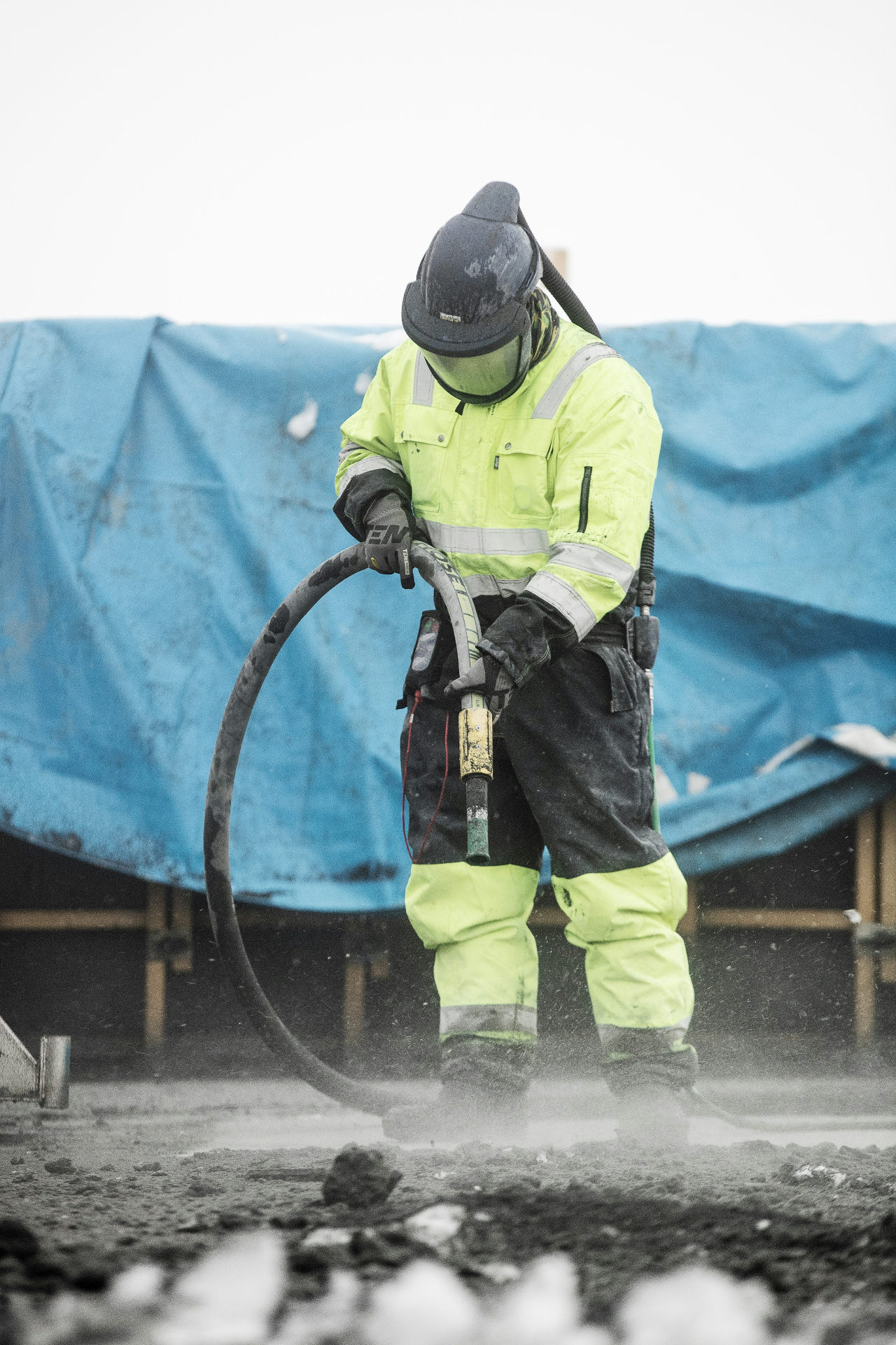 Close-up of industrial sandblasting process on steel pipe